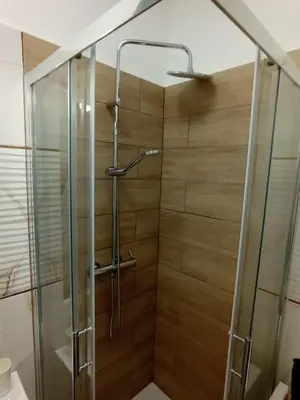 a bathroom with a shower with a glass door at Capsule 12- Old Town , Steps to the Station , Maximum Convenience in Kraków