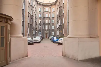 an alley with cars parked in front of buildings at Capsule 12- Old Town , Steps to the Station , Maximum Convenience in Kraków