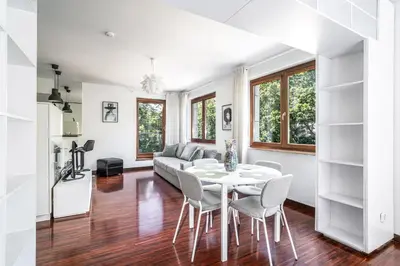 a living room with a table and chairs and a couch at RentPlanet - Apartament Kazimierza Wielkiego in Kraków