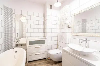 a white bathroom with a sink and a toilet at RentPlanet - Apartament Kazimierza Wielkiego in Kraków