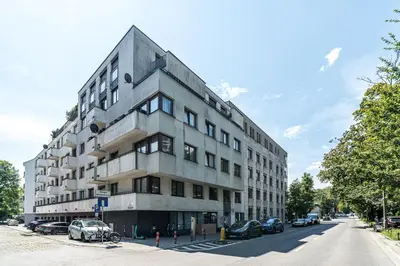 a building on a street with cars parked in front of it at RentPlanet - Apartament Kazimierza Wielkiego in Kraków