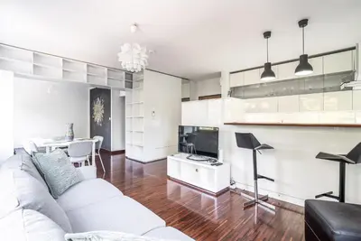 a living room with a white couch and a table at RentPlanet - Apartament Kazimierza Wielkiego in Kraków