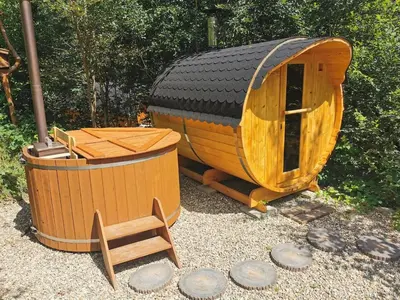 a small wooden sauna and a wooden barrel at Hope Mountain Escape Poland, Charming Barrel House in Szczawa