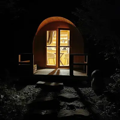 a small room with a door in the dark at Hope Mountain Escape Poland, Charming Barrel House in Szczawa