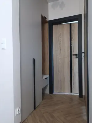 an open door in a room with a wooden floor at Apartament pod Groniem in Zawoja