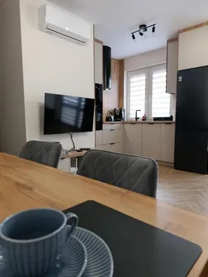 a kitchen and a table with a cup on top of it at Apartament pod Groniem in Zawoja