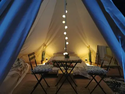 a tent with two chairs and a table in it at Hope Mountain Escape Poland, Awesome Glamping Tent in Szczawa
