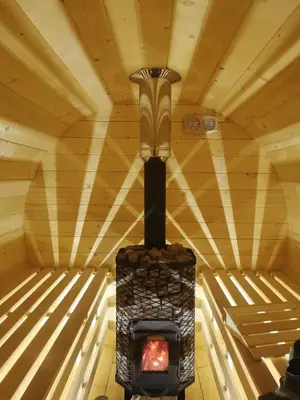a fireplace in a room with a wooden ceiling at Hope Mountain Escape Poland, Awesome Glamping Tent in Szczawa