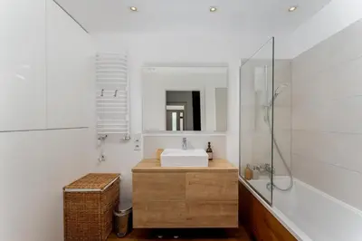a bathroom with a sink and a mirror at Cricoteque Residence - Luxury 1BR Riverside Suite in Kraków