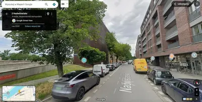 a row of cars parked on a city street at Cricoteque Residence - Luxury 1BR Riverside Suite in Kraków