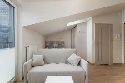 a living room with a bed and a couch at Kalwaryjska Elegant Stay Studios by BookingHost in Kraków