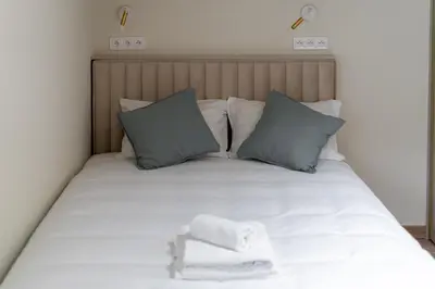 a bed with two towels on top of it at Kalwaryjska Elegant Stay Studios by BookingHost in Kraków