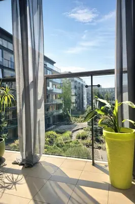 a balcony with chairs and plants in a room at LA BELLE SUITE near Old Town & Kazimierz UNDERGROUND GARAGE INCLUDED in Kraków