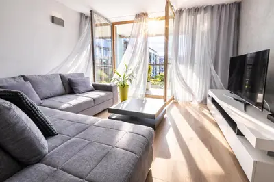 a living room with a glass table and chairs at LA BELLE SUITE near Old Town & Kazimierz UNDERGROUND GARAGE INCLUDED in Kraków