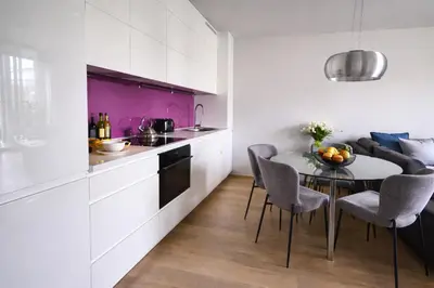a bedroom with a large bed and a living room at LA BELLE SUITE near Old Town & Kazimierz UNDERGROUND GARAGE INCLUDED in Kraków