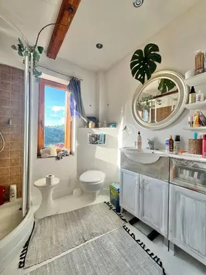 a bathroom with a toilet and a sink and a mirror at Dom Ponad Wsią in Zawoja