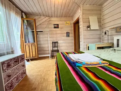 a bedroom with a bed with a colorful blanket at Dom Ponad Wsią in Zawoja