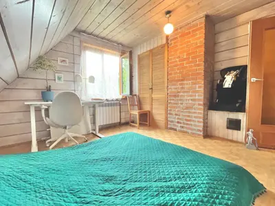 a bedroom with a bed and a desk and a brick wall at Dom Ponad Wsią in Zawoja