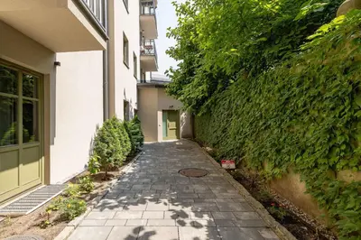 a stone walkway in front of a building at Stylish Apartment Dietla with Balcony in Kraków by Noclegi Renters in Kraków