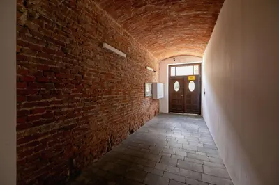 a brick hallway with a door and a brick wall at Stylish Apartment Dietla with Balcony in Kraków by Noclegi Renters in Kraków