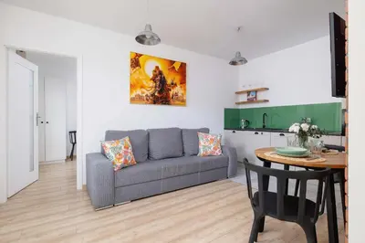 a living room with a couch and a table at Stylish Apartment Dietla with Balcony in Kraków by Noclegi Renters in Kraków