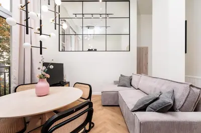a living room with a couch and a table at The Vitrail Apartments - by Upstairs in Kraków