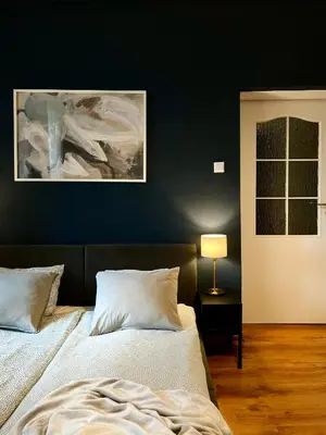 a bedroom with a bed and a painting on the wall at Beautiful apartments Kazimierz District, Kraków Old Town City Center in Kraków