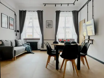 a living room with a table and chairs and a couch at Beautiful apartments Kazimierz District, Kraków Old Town City Center in Kraków
