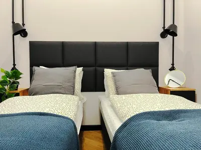 two beds sitting next to each other in a room at Beautiful apartments Kazimierz District, Kraków Old Town City Center in Kraków