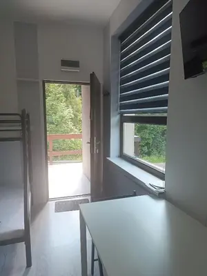 a room with a table and a window with blinds at Apartament w Kocierzu in Kocierz Rychwałdzki