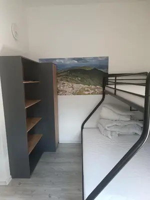 a black bunk bed in a room with a wall at Apartament w Kocierzu in Kocierz Rychwałdzki