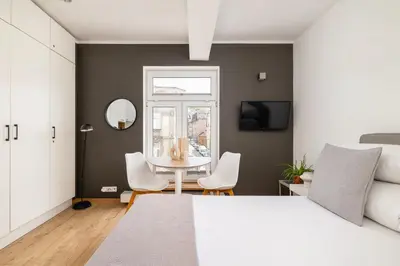a bedroom with a bed and a table and chairs at Studio apartment - Kalwaryjska 34 street in Kraków