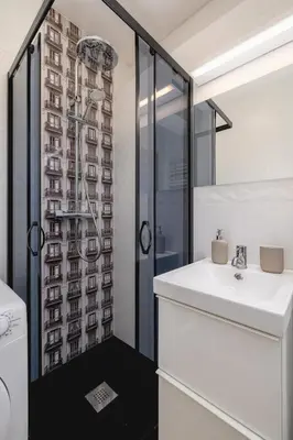 a bathroom with a sink and a shower at Studio apartment - Kalwaryjska 34 street in Kraków