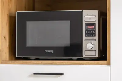 a microwave oven sitting on top of a shelf at Studio apartment - Kalwaryjska 34 street in Kraków