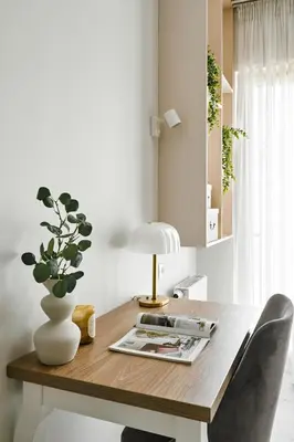 a wooden table with a lamp and a plant on it at City Dreams Apartment in Kraków