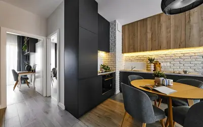 a kitchen and dining room with a table and chairs at City Dreams Apartment in Kraków