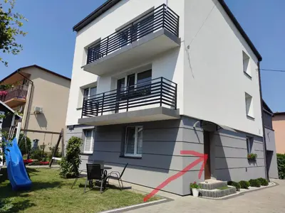 a white building with a balcony on the side of it at Lawendowy Zakątek in Wadowice