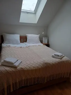 a bedroom with a bed with two towels on it at Fundacja DPT Zawoja Dom Pracy Twórczej PAU in Zawoja