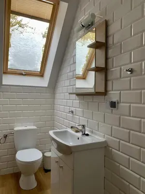 a bathroom with a toilet and a sink and a window at Fundacja DPT Zawoja Dom Pracy Twórczej PAU in Zawoja