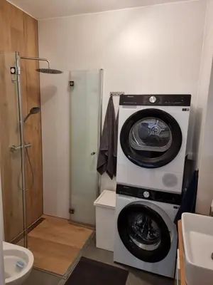 a washer and dryer in a bathroom with a sink at K Everhome in Kraków