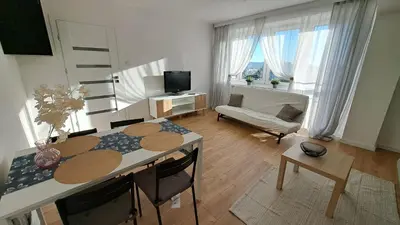 a living room with a table and a couch at Przy Parku Wyspiańskiego in Kraków