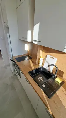 a kitchen with a sink and a counter at Przy Parku Wyspiańskiego in Kraków