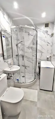 a white bathroom with a toilet and a shower at Przy Parku Wyspiańskiego in Kraków
