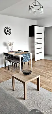 a living room with a table and a dining room at Przy Parku Wyspiańskiego in Kraków