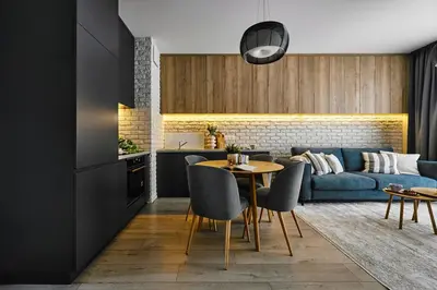 a living room with a blue couch and a table at Velvet Dreams Apartments 46 in Kraków