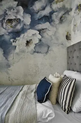 a bedroom with a bed and a painting of clouds at Velvet Dreams Apartments 46 in Kraków
