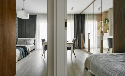 a bedroom with a bed and a desk and a room at Velvet Dreams Apartments 46 in Kraków
