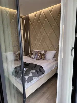 a bed in a room with a mirror at Apartament Deluxe Wiślane Tarasy 2 I Parking in Kraków