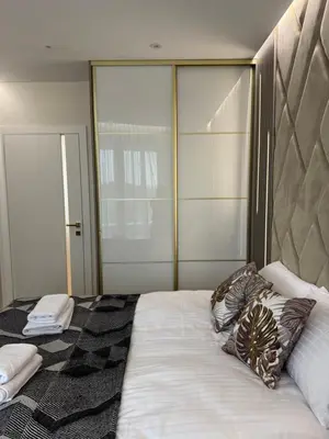 a bedroom with a large bed with pillows on it at Apartament Deluxe Wiślane Tarasy 2 I Parking in Kraków