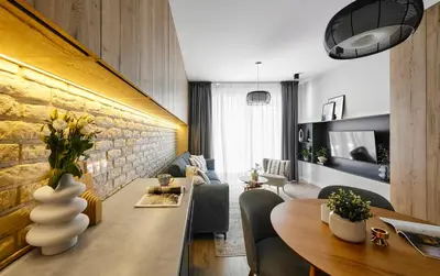 a living room with a dining table and a living room with a couch at Velvet Dreams Apartments 49 in Kraków